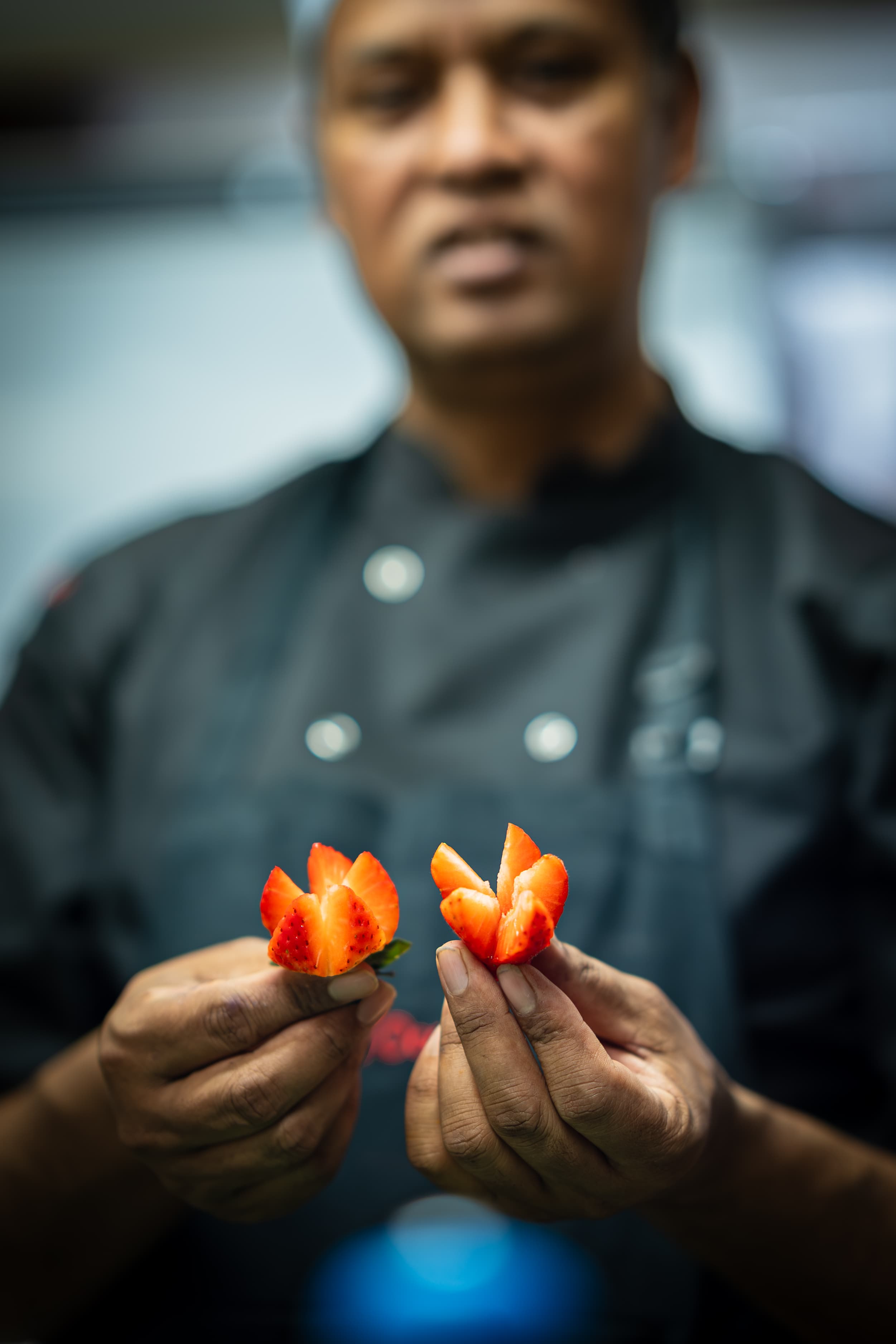 Chef finishing a strawberry garnish