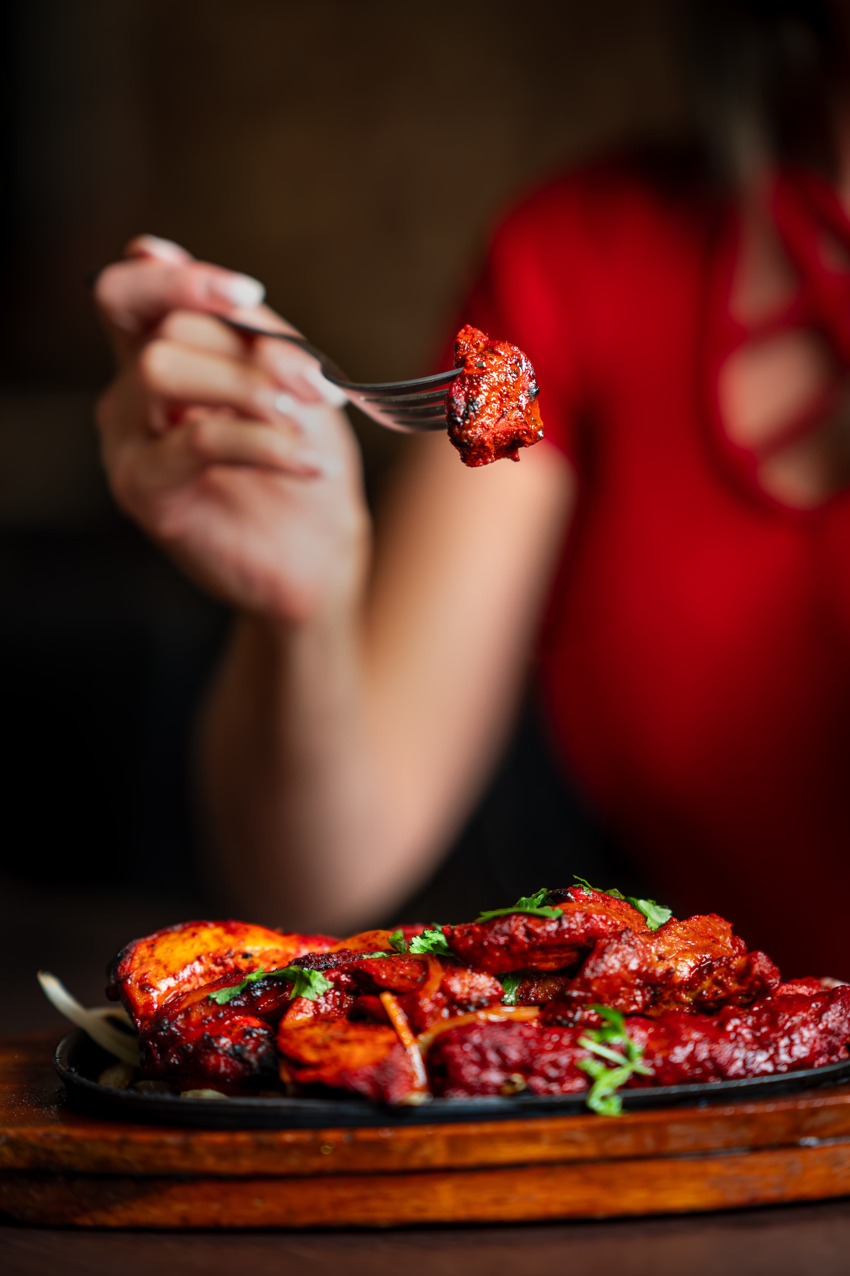 Chicken tikka lifted from a sizzler platter